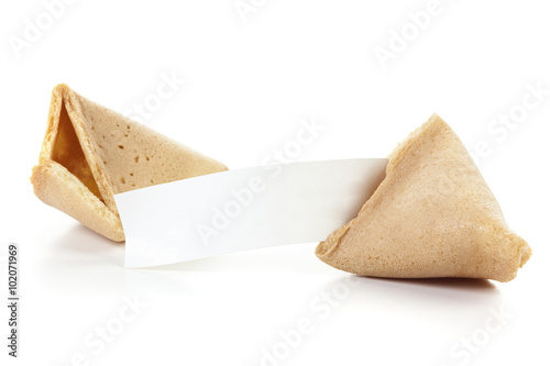 Fortune cookie with blank message slip isolated. Broken fortune cookie with blank paper isolated on white background