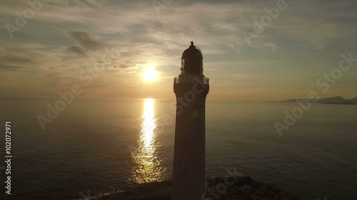 Stunning aerial shot of Ardnamurchan lighthouse on the coast of Scotland during a sunset 
 photo