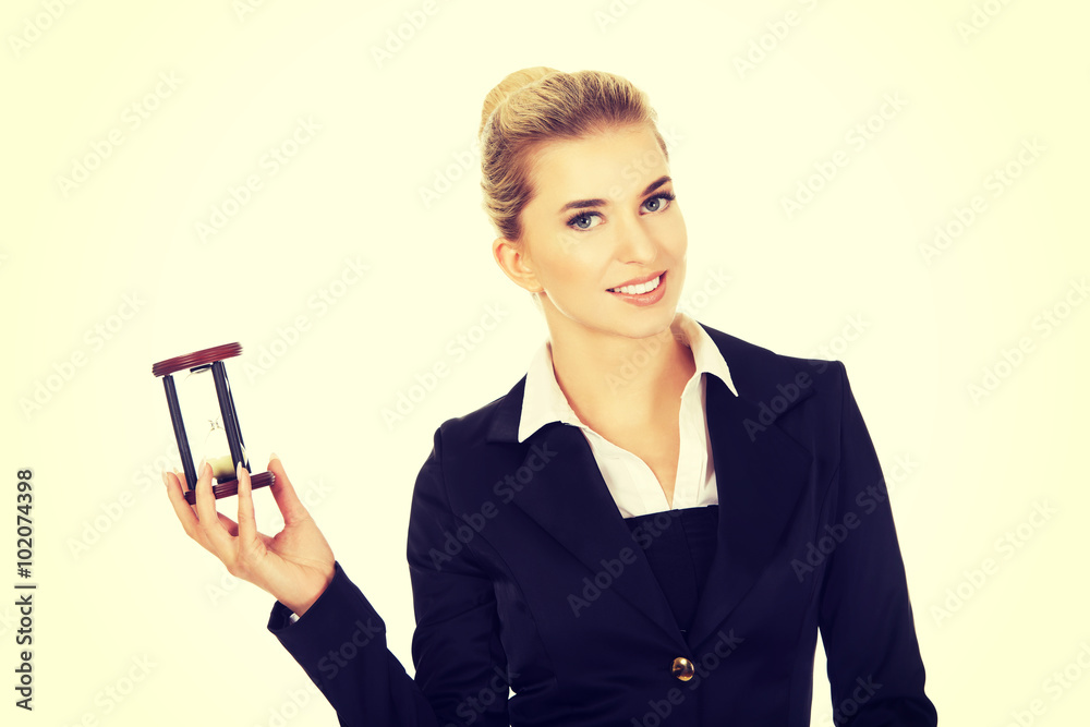 Young smile businesswoman with hourglass - time concept Young smile businesswoman with hourglass - time concept
