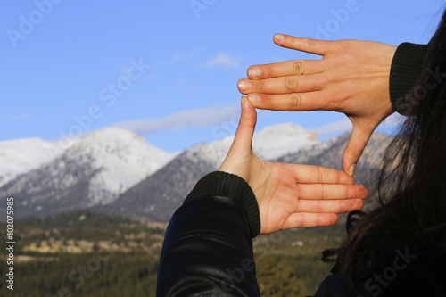 The woman hand framing distant.