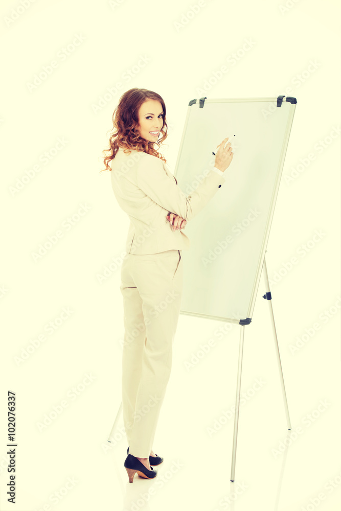 Business woman writing on flipchart. Business woman writing on flipchart.