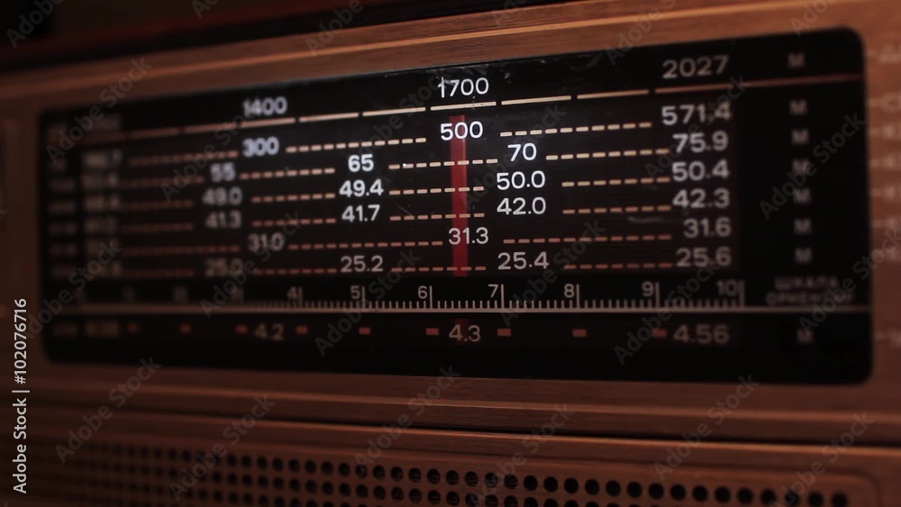 Close up of a vintage radio dial with the stations and frequencies being tuned