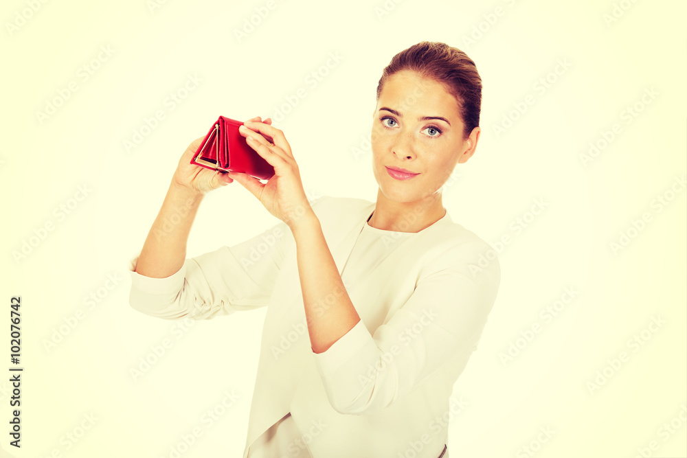 Shocked businesswoman looking into her empty wallet Shocked businesswoman looking into her empty wallet