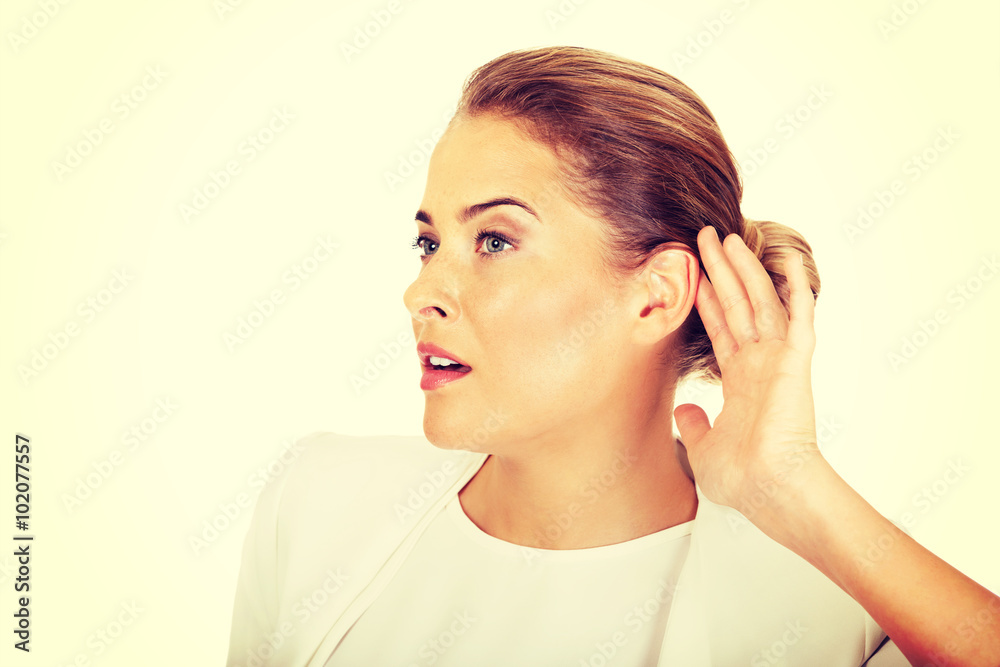 Beautiful businesswoman overhears a conversation Beautiful businesswoman overhears a conversation