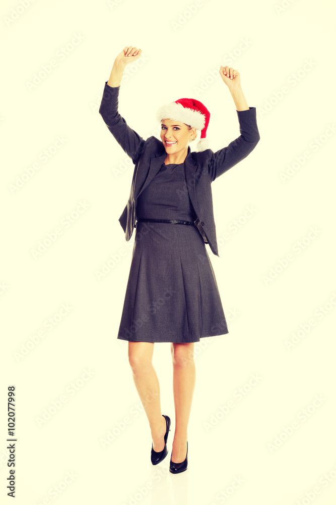 Happy businesswoman wearing christmas hat Happy businesswoman wearing christmas hat