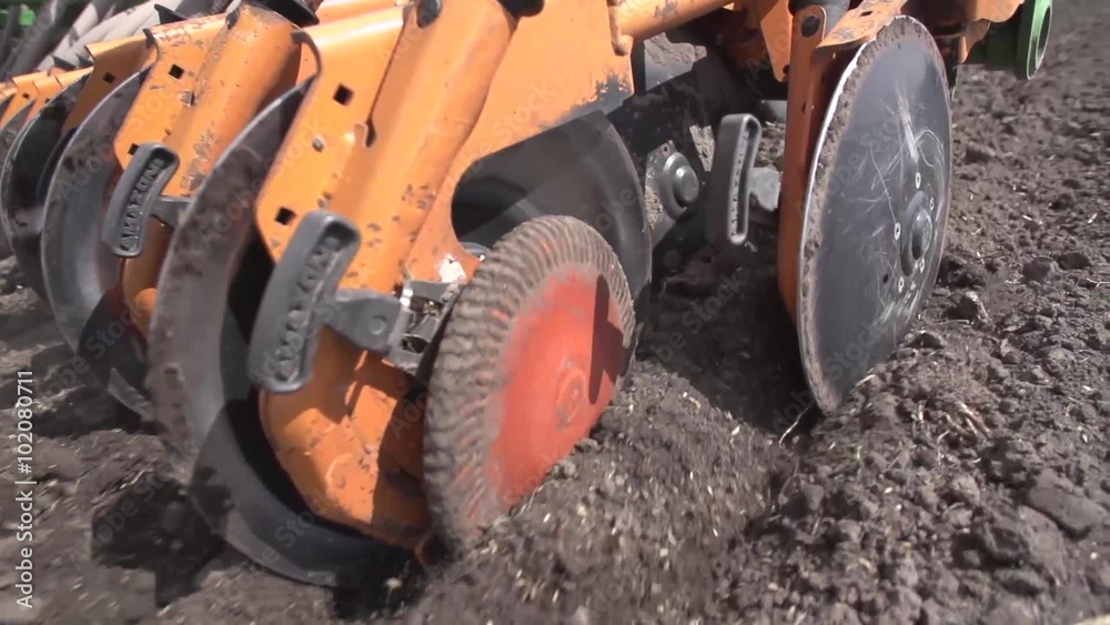Close up of a tractor seeding, plowing and cultivating the field in the spring. Agriculture concept. Tracking shot. Close up of a tractor seeding, plowing and cultivating the field in the spring. Agriculture concept. Tracking shot.