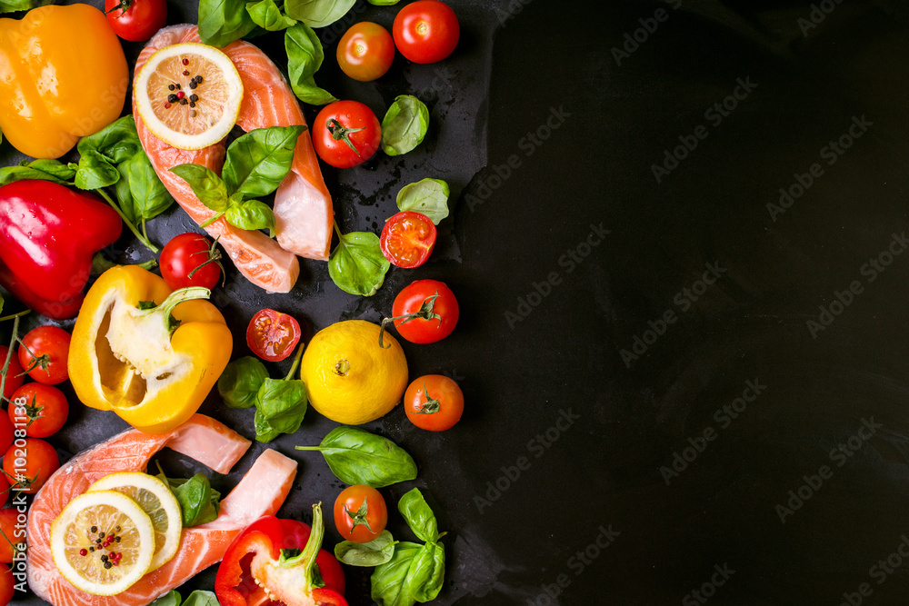 Raw salmon steaks and fresh ingredients for cooking. Frame Raw salmon steaks and fresh ingredients for cooking. Frame
