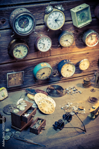 Vintage watchmaker's workshop with parts of clocks