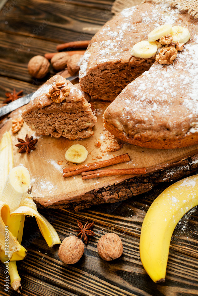 pastries, cake with walnuts and a banana with powdered sugar on a wooden background
pastries, cake with walnuts and a banana with powdered sugar on a wooden background