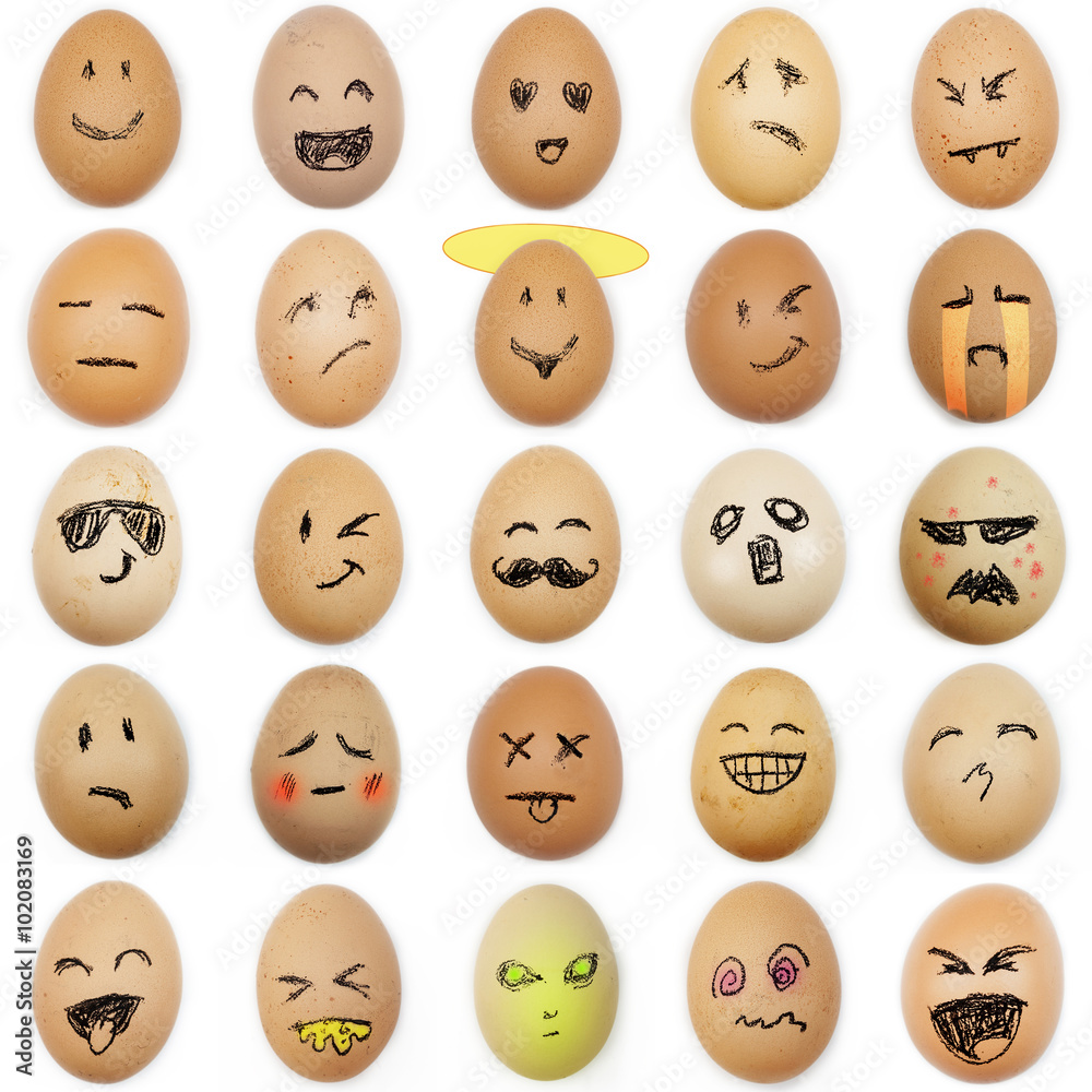 Fototapeta premium multitude of different smiley faces drawn on the eggshell on whi
