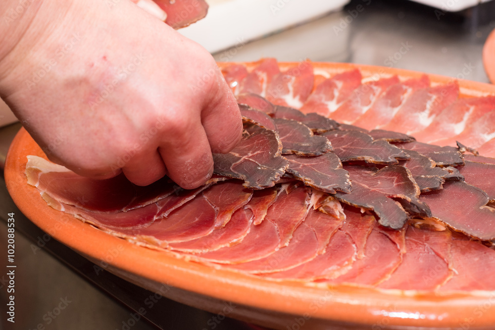 Arranging cured meat on a plate