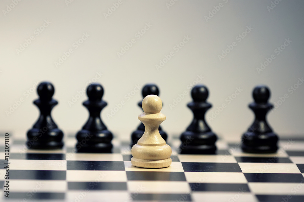 figure white against the black pawn on the chessboard figure white against the black pawn on the chessboard