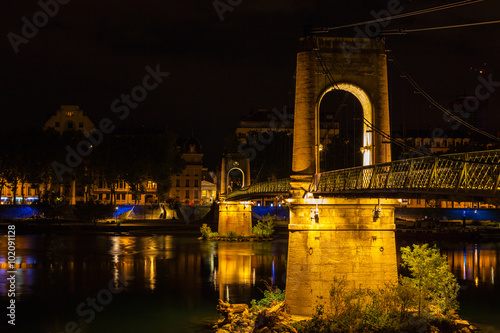 Bridge over Rhone river in Lyon, France at night