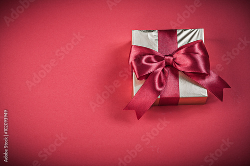 Gift box on red background holidays concept