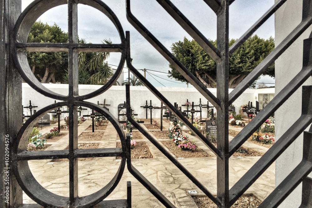 cemetary through a fence cemetary through a fence