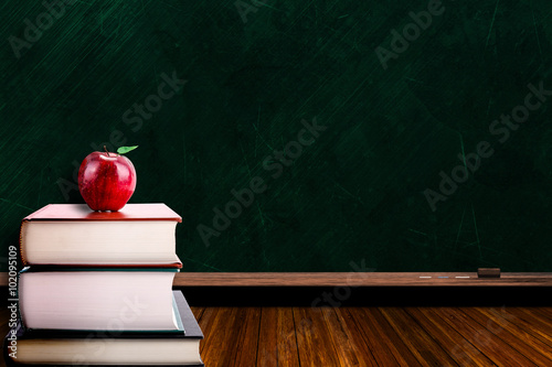 Education Concept With Apple on Books and Blackboard Background