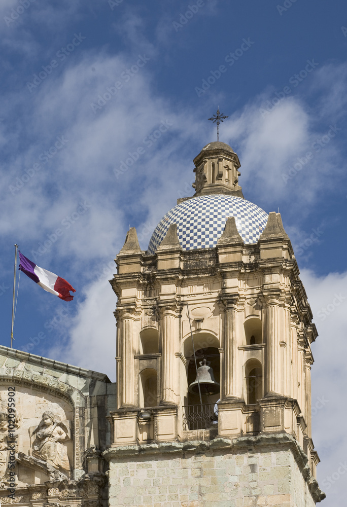 Mexican flag and bell tower of Santo Domingo church, Oaxaca City, Oaxaca, Mexico