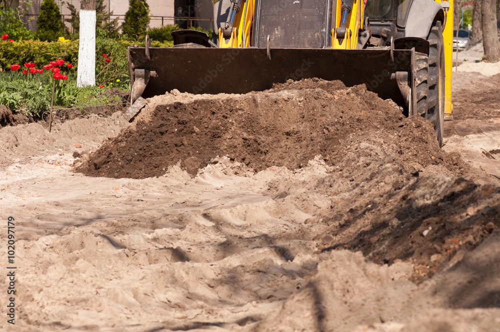 excavator removes the sand at the construction site excavator removes the sand at the construction site