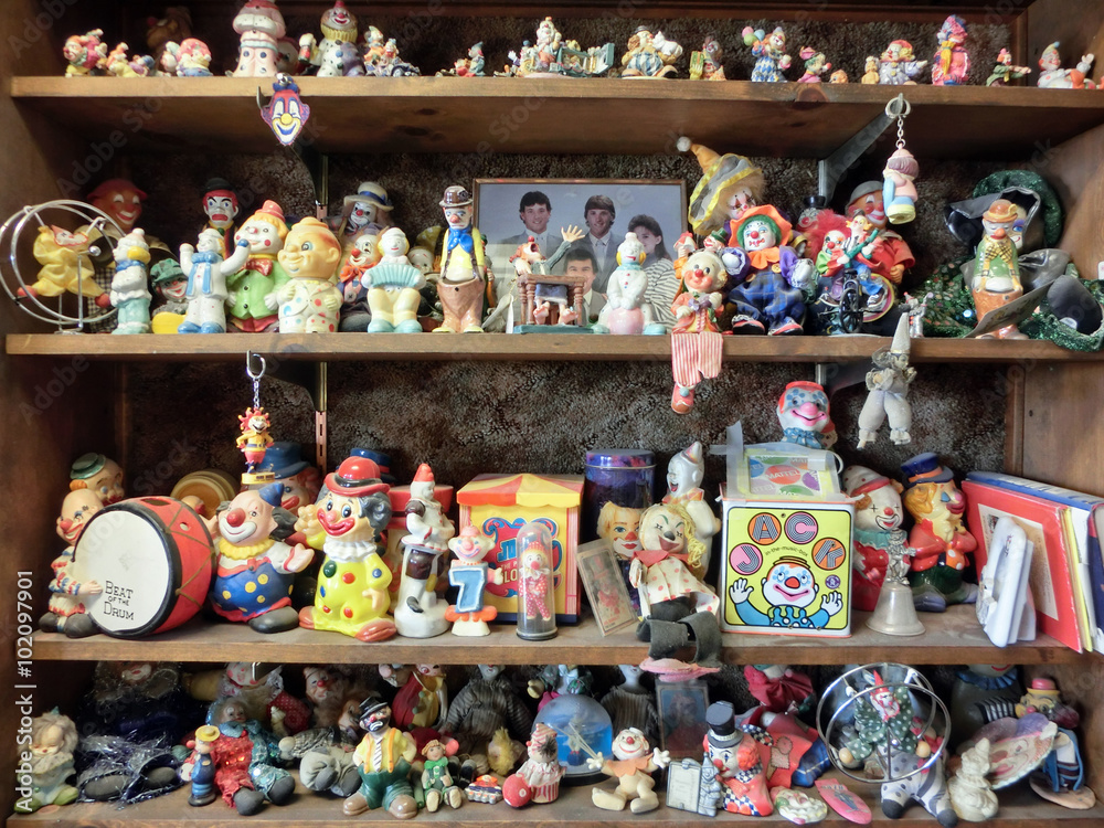 Shelves full of creepy clown toys - landscape photo
