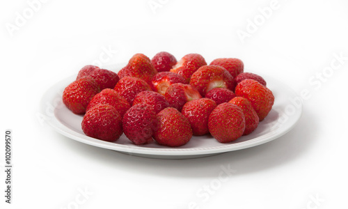 Heap of prepared strawberry on plate, isolated