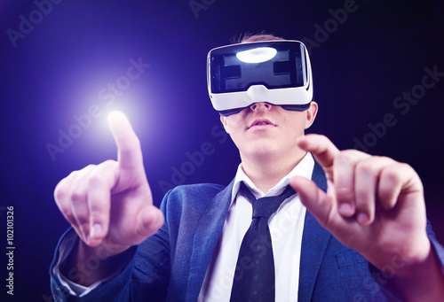 Businessman uses Virtual Realitiy VR head-mounted display photo