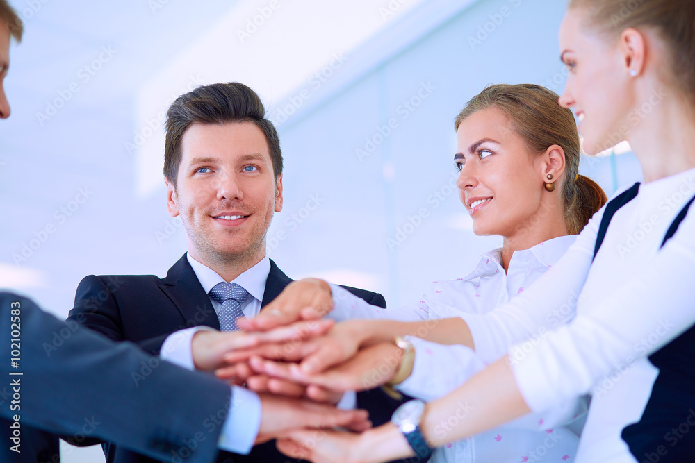 Business people with their hands together in a circle Business people with their hands together in a circle