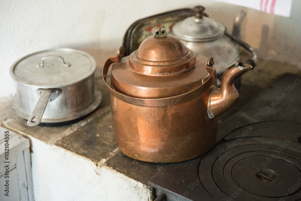 old-fashioned copper tea kettle on a stove old-fashioned copper tea kettle on a stove
