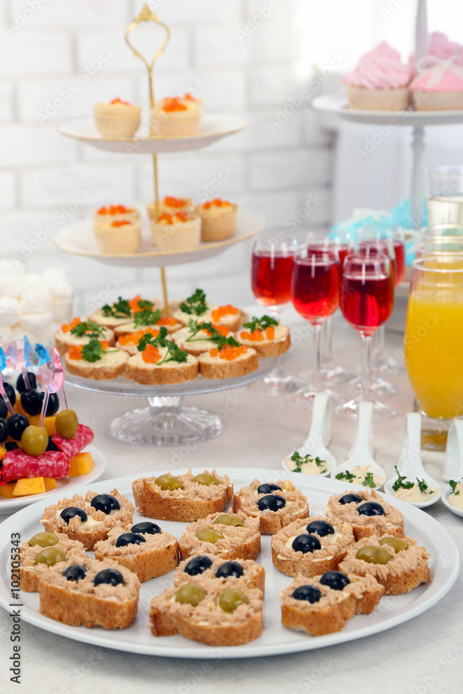 Set of cold snacks, canape, beverages and dessert, closeup Set of cold snacks, canape, beverages and dessert, closeup