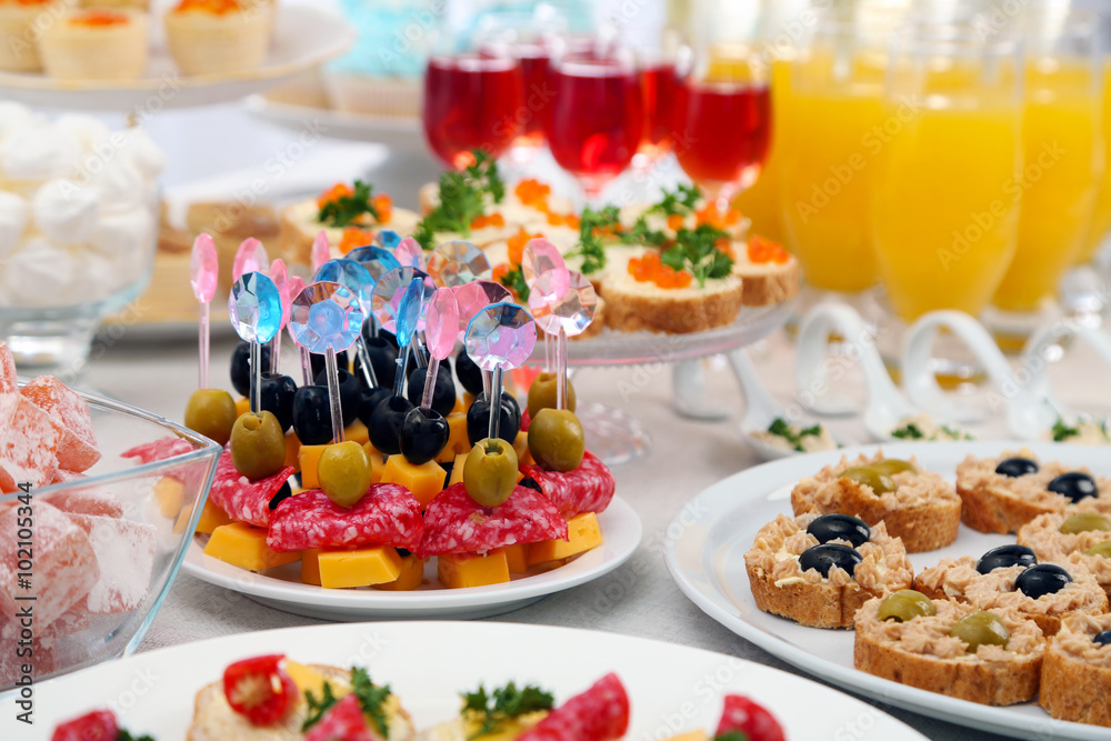 Set of cold snacks, canape, beverages, closeup Set of cold snacks, canape, beverages, closeup