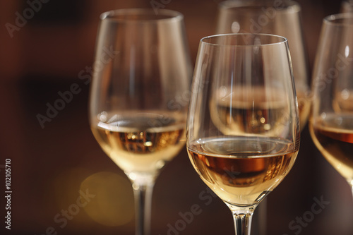 Glasses with white wine on blurred background