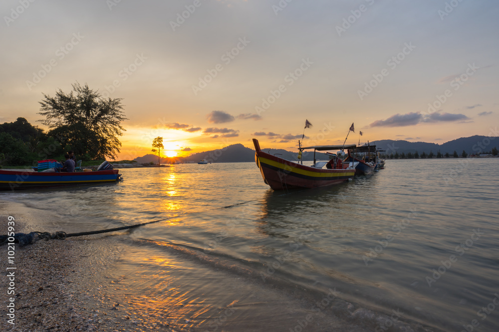 Fisherman boat at the beach during sunset