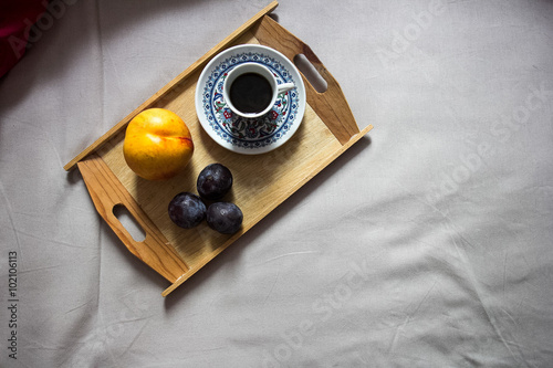 .Morning coffee with fruit in bed