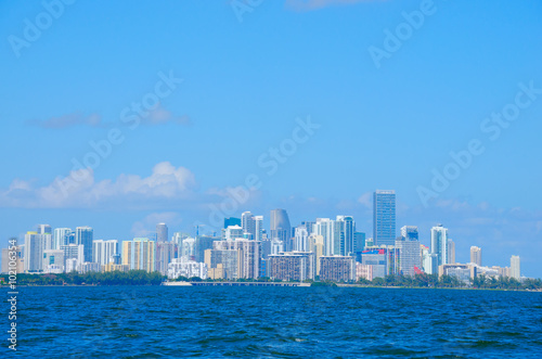 Colorful photo of the Miami skyline as viewed off of the coastline in Biscayne Bay, Florida on a blue sky sunny morning. © Michael O'Keene