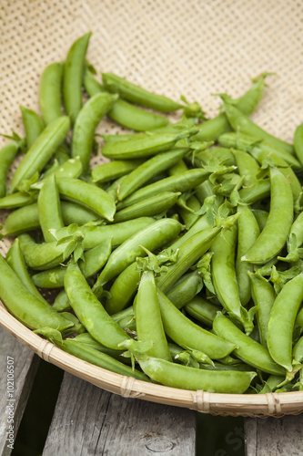 Organic snap peas in basket at farmers market