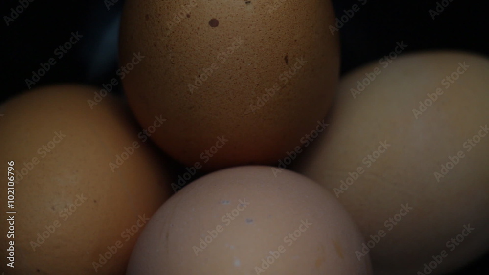 Five Eggs Rotating on Black Plate