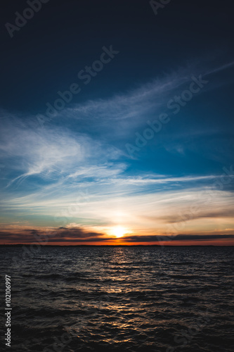 Calm sunset and clouds over lake