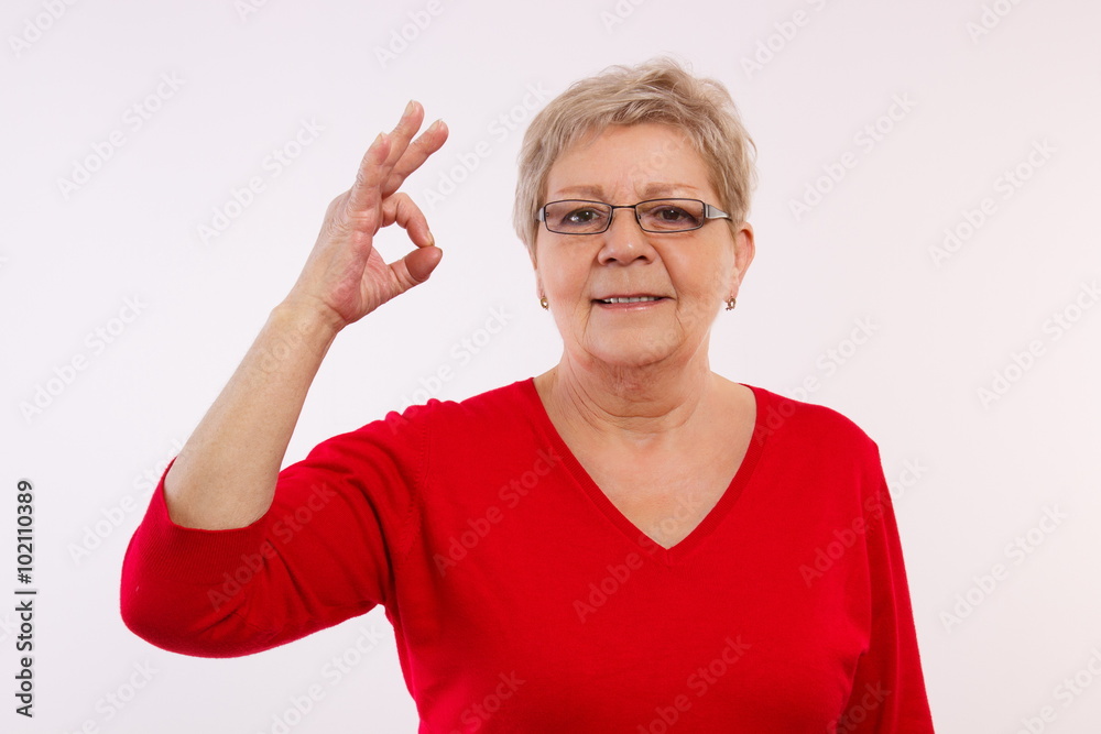 Happy smiling elderly woman showing sign ok, positive emotions in old age Happy smiling elderly woman showing sign ok, positive emotions in old age