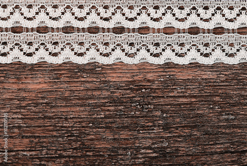 Openwork lace on wooden background