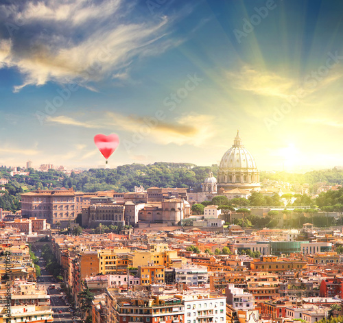 Aerial View of St. Peter's cathedral in Rome, Italy at sunset with red balloon in form of heart. Counter light shot. Business, Love and travel concept