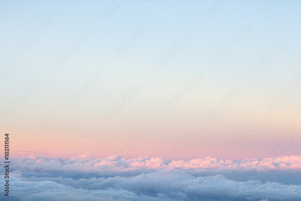 Background: above the clouds on beautiful sunset sky