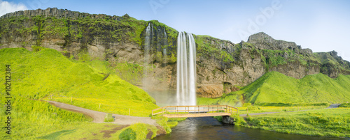 wood bridge under big waterfall in Iceland