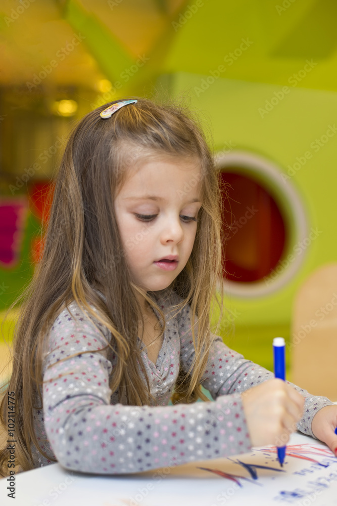 Little girl drawing at playroom Little girl drawing at playroom