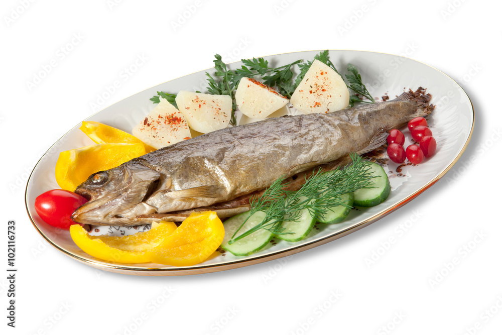Baked trout with vegetables on the plate on a white background Baked trout with vegetables on the plate on a white background