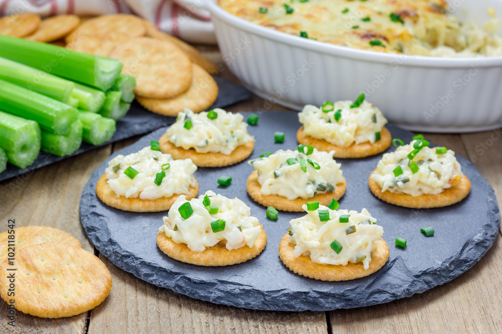 Baked crab dip, served with celery sticks and crackers