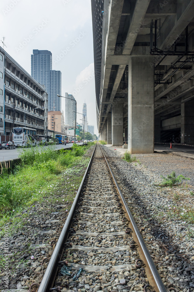 railway track with background of building road and train station Stock  Photo | Adobe Stock