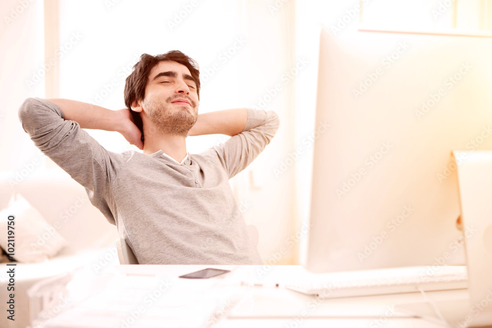 Young man relaxing during a break at the office Young man relaxing during a break at the office