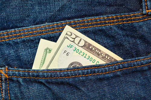 dollars in the back pocket of jeans
