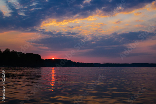 sunset and reflection with dramatic sky (toned image)