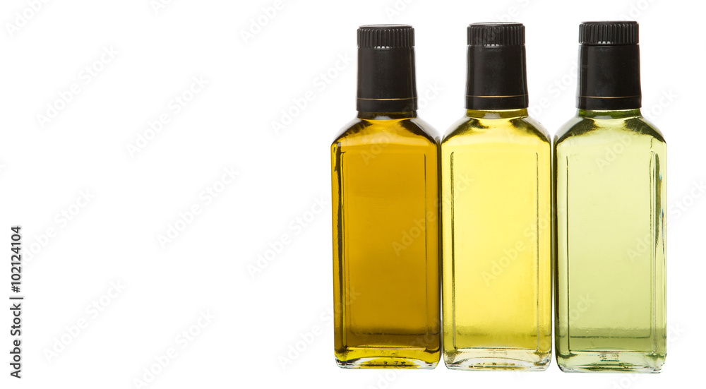 Avocado oil, olive oil and rapeseed oil over white background