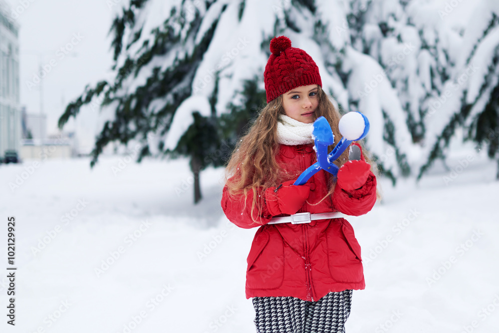 Portrait of lovely little girl holding snowball maker Portrait of lovely little girl holding snowball maker